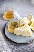 Sulguni cheese and amber-coloured wine on a textured background