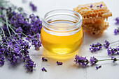 Jar of honey and fresh lavender flowers