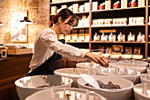 Chocolate shop employee arranges products