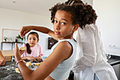 Family enjoying baking biscuits in a modern kitchen