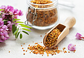 Healthy bee pollen grains. Bee pollen on a glass jar and acacia