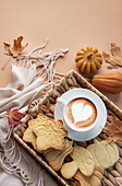 Cup of coffee, cookies on tray, yellow leaves.