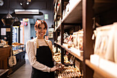 Chocolate shop employee arranging products