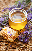 Jar of honey and fresh lavender flowers