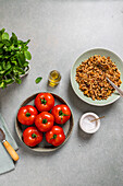 Fresh tomatoes and seasoned brown rice on a kitchen counter