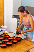 Woman preparing vegan dishes in a healthy eating workshop