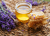 Jar of honey and fresh lavender flowers