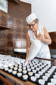 Baker preparing pastries with a piping bag