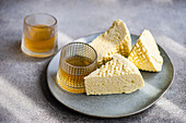 Sulguni cheese and amber-coloured wine on a textured background