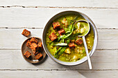Cream of cauliflower and oat soup with wild garlic and croutons