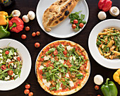 Typical Italian dishes: pizza, penne, calzone, salad
