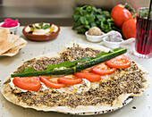 Zaatar manakish with labneh, tomato, cucumber and mint