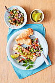 Indian spiced salmon with cucumber and tomato salad and naan bread