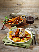 Braised beef roulades with roast potatoes and bacon