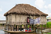 Benin, lakeside city of Ganvié, women talking together in front of a stilt house