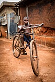 Benin, Kouffo district, Azove, child riding bike