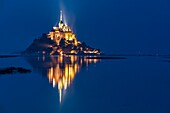 France, Manche, Mont Saint Michel Bay listed as World Heritage by UNESCO, Abbey of Mont Saint Michel and River Couesnon at dusk