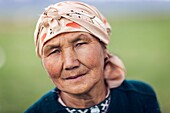 Kyrgyzstan, Naryn Province, Son-Kol Lake, altitude 3000m, portrait of a Kyrgyz woman wearing a headscarf