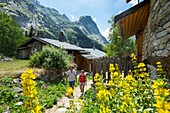 France, Savoie, Mountain of Vanoise, Pralognan la Vanoise, a couple crosses on a hiking trail the hamlet of Fontanettes and the rock of Valletta