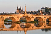 France, Loir et Cher, Loire Valley listed as World Heritage by UNESCO, Blois, Pont Jacques Gabriel, bridge over Loire river and in background, the castle and Saint Nicolas church