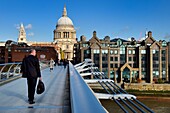 United Kingdom, London, the City, the Millennium Bridge by architect Norman Foster on the Thames river and St. Paul's Cathedral in the background