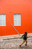 South Africa, Western Cape, Child near a colorful house in the Bo-Kaap neighborhood in downtown Cape Town