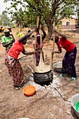 Benin, Abomey, women milling yams to make pureed yams