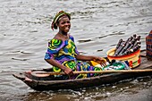 Benin, lakeside city of Ganvié, sugar cane saleswoman