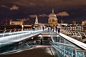 United Kingdom, London, the Millennium Bridge by architect Norman Foster on the Thames river and St. Paul's Cathedral in the background