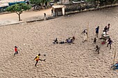 Ivory Coast, Grand Bassam, kids playing football on the beach