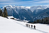 France, Savoie, Beaufortain massif, Areches Beaufort, family resort, snowshoe hike over Beaufort