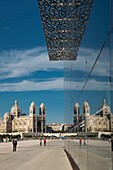 France, Bouche du Rhone, Marseille, La Major cathedral is reflected in the glass walls of Mucem