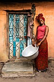 Benin, Natitingou district, woman back from washing clothes