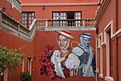 Spain, Canary Islands, Tenerife Island, La Orotava, terracotta wall decorated with a fresco depicting women in traditional Canarian costume