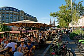 France, Bas-Rhin, Strasbourg, old town listed as World Heritage by UNESCO, cafes boats on the Quai des Bateliers on the banks of the Ill river and Saint-Paul Church in the background