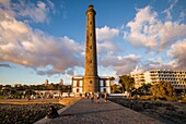 Spain, Canary Islands, Gran Canaria Island, Maspalomas, Maspalomas Lighthouse, sunset with visitors