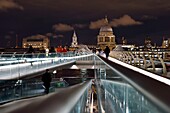 United Kingdom, London, the Millennium Bridge by architect Norman Foster on the Thames river and St. Paul's Cathedral in the background