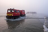 France, Manche, Mont Saint Michel Bay listed as World Heritage by UNESCO, Abbey of Mont Saint Michel, VCA (Amphibious Vehicle Chenille) of the SDIS 50, fog