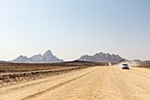 Namibia, Erongo province, Spitzkoppe, a car on the gravel road