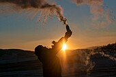 China, Inner Mongolia, Hebei Province, Zhangjiakou, Bashang Grassland, Colline landscape, men sending water or milk in the cold air, ritual scene