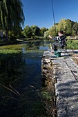 France, Loiret, Loire valley,Briare, lateral canal to the Loire, angler by the canal