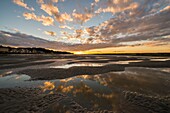 France, Somme, Baie de Somme, Saint-Valery-sur-Somme, Twilight over the village from the Somme channel at low tide