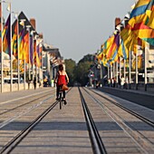 France, Indre et Loire, Loire valley listed as World Heritage by UNESCO, Tours, the Loire in Tours, young woman cycling on Wilson Bridge