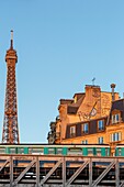 France, Paris, the riverbanks of the Seine river listed as World Heritage by UNESCO, facades of apartment buildings in Quai de Grenelle , the Eiffel tower and line 6 of the Metro