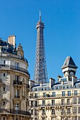 France, Paris, the clock tower in shape of a belfry in Avenue Rapp and facades of apartment buildings