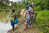 Papua New Guinea, Southern Highlands Province, Lake Kutubu, people are carring UNICEF Family Hygiene and Dignity kits