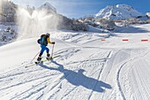 France, New Aquitaine, Pyrenees-Atlantiques, ski resort of Gourette (locality of the commune of Eaux-Bonnes), a skier goes in a circle passing in front of snow cannons