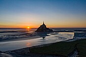 France, Manche, The Mont Saint Michel at sunrise, from a drone machine