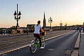 France, Gironde, Bordeaux, area listed as World Heritage by UNESCO, the Pont de Pierre over the Garonne, at the bottom the spire and the Saint-Michel Basilica in Bordeaux