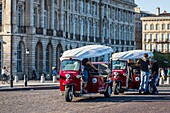 France, Gironde, Bordeaux, area classified as World Heritage by UNESCO, Saint-Pierre district, Place de la Bourse, electric motorcycle taxi tricycle